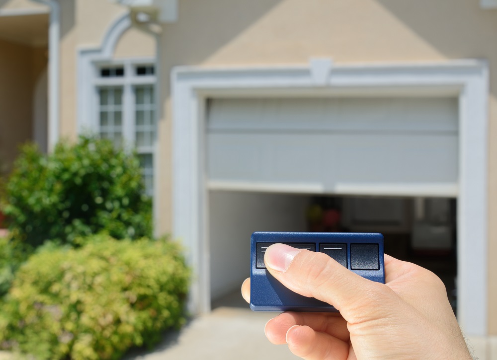 Hand Holding a Garage Door Opener